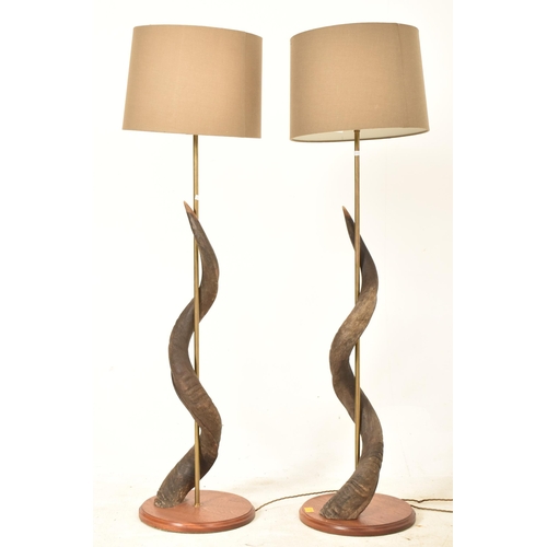 70 - A large pair of 20th century believed Greater Kudu horn lamp lights. Each lamp having a beige drum s... 
