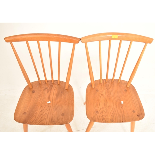 93 - Ercol - A matching pair of retro 20th century beech and elm dining chairs. Each chair with spindle b... 