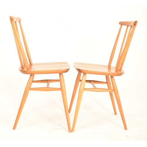 93 - Ercol - A matching pair of retro 20th century beech and elm dining chairs. Each chair with spindle b... 