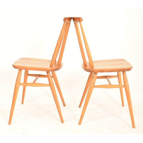 93 - Ercol - A matching pair of retro 20th century beech and elm dining chairs. Each chair with spindle b... 