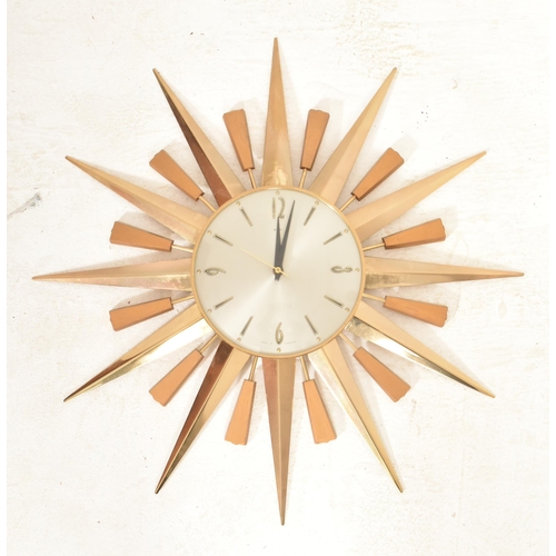 116 - Metamic - A retro 20th century sunburst / starburst wall clock. Central circular dial with faceted h... 