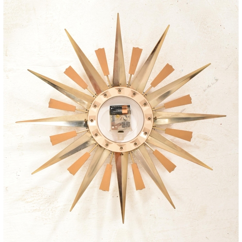 116 - Metamic - A retro 20th century sunburst / starburst wall clock. Central circular dial with faceted h... 