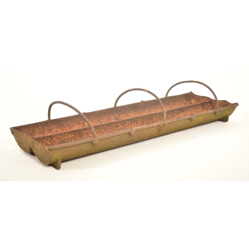 618 - An early 20th century cast iron animal feeder trough / garden planter. Elongated dual bank form with... 