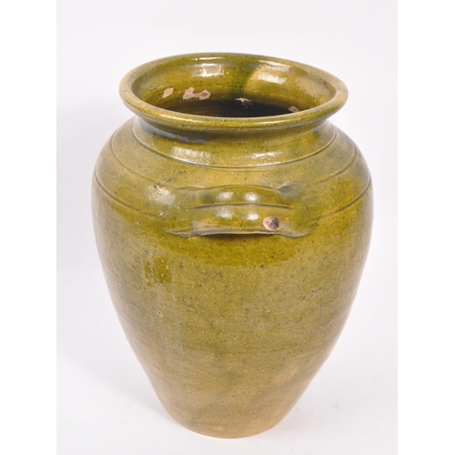 101 - A 19th Century large green Chinese pottery twin handled vase. Having a large round drip glazed taper... 