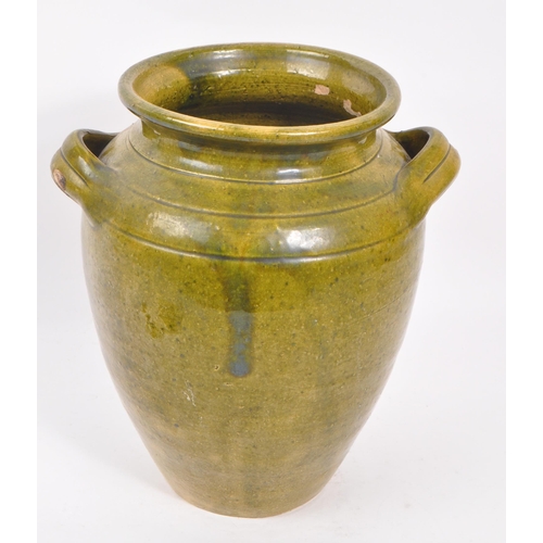 101 - A 19th Century large green Chinese pottery twin handled vase. Having a large round drip glazed taper... 