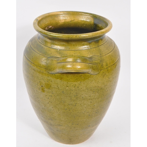 101 - A 19th Century large green Chinese pottery twin handled vase. Having a large round drip glazed taper... 