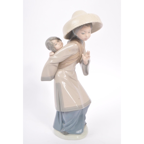 15 - Lladro - A late 20th century retired Lladro porcelain figure. The figure no.5123 ' My Precious Bundl... 