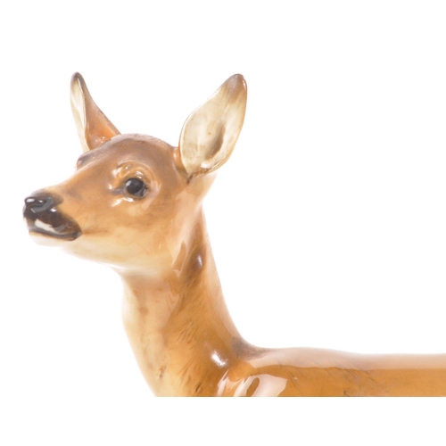 186 - Hutschenreuther - A mid 20th century Hutschenreuther porcelain deer figurine. The figure depicting a... 