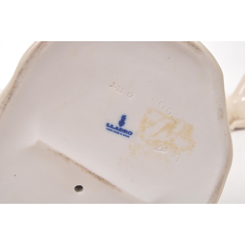 195 - Lladro - A collection of four 20th Century porcelain china Lladro figurines comprising of three golf... 