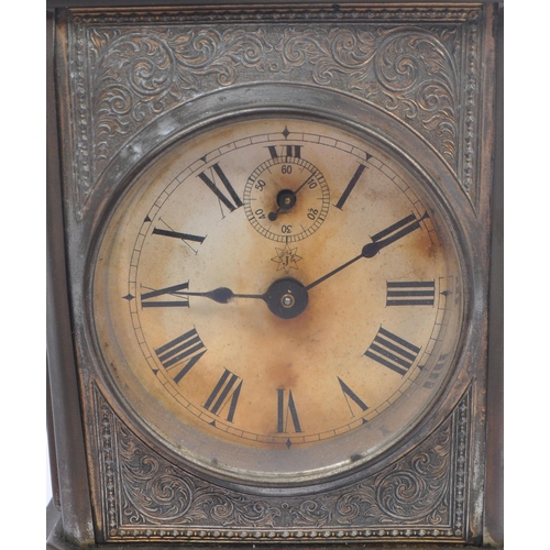 206 - Junghans -  A 19th century base metal carriage style clock with round Roman dial and glass side pane... 