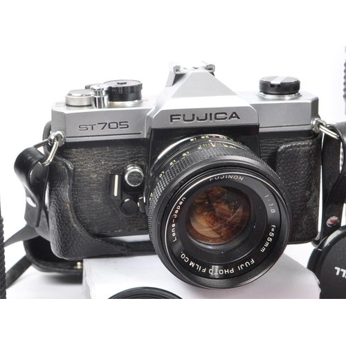 209 - A collection of late 20th century 35mm cameras and lenses. The collection to include Pentax P30N and... 