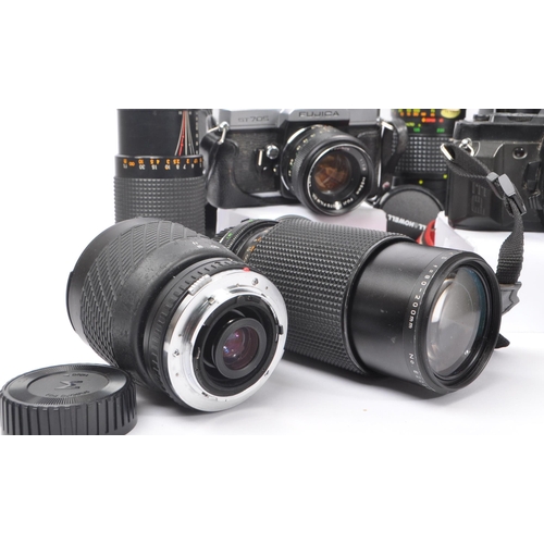 209 - A collection of late 20th century 35mm cameras and lenses. The collection to include Pentax P30N and... 