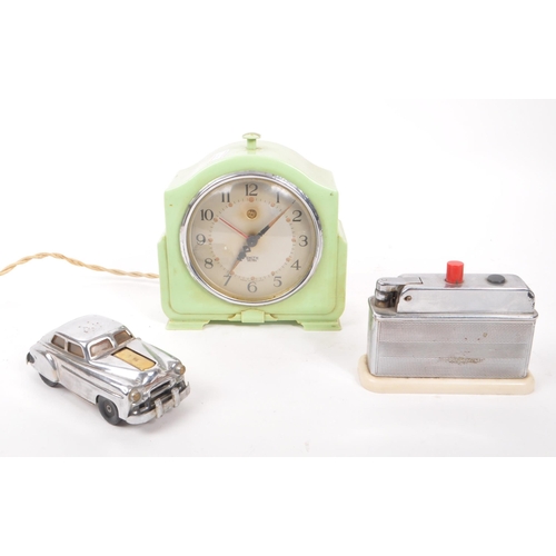 215 - An early 20th century Art Deco Smiths bakelite mantel clock, alongside two early 20th century table ... 