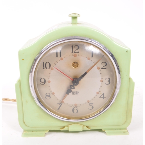 215 - An early 20th century Art Deco Smiths bakelite mantel clock, alongside two early 20th century table ... 