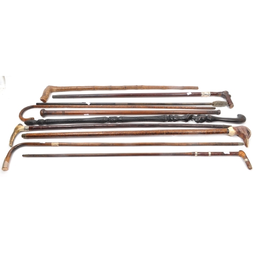 216 - A collection of Edwardian and later swagger sticks / walking canes. Some examples including duck hea... 