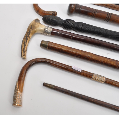 216 - A collection of Edwardian and later swagger sticks / walking canes. Some examples including duck hea... 