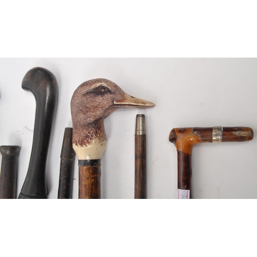 216 - A collection of Edwardian and later swagger sticks / walking canes. Some examples including duck hea... 