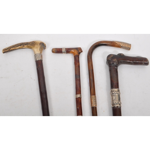 216 - A collection of Edwardian and later swagger sticks / walking canes. Some examples including duck hea... 