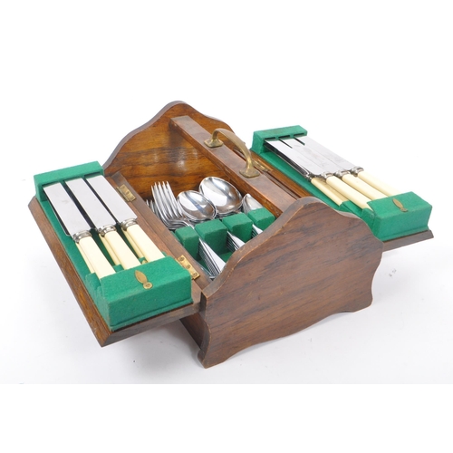 219 - Bolen & Sons - A 20th Century canteen of cutlery for six people having faux ivorine plastic handles.... 