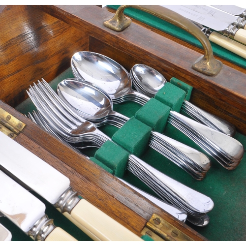 219 - Bolen & Sons - A 20th Century canteen of cutlery for six people having faux ivorine plastic handles.... 