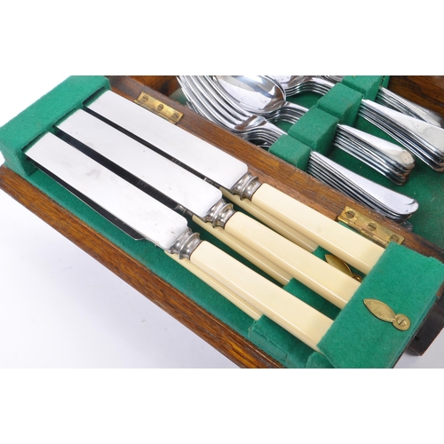 219 - Bolen & Sons - A 20th Century canteen of cutlery for six people having faux ivorine plastic handles.... 