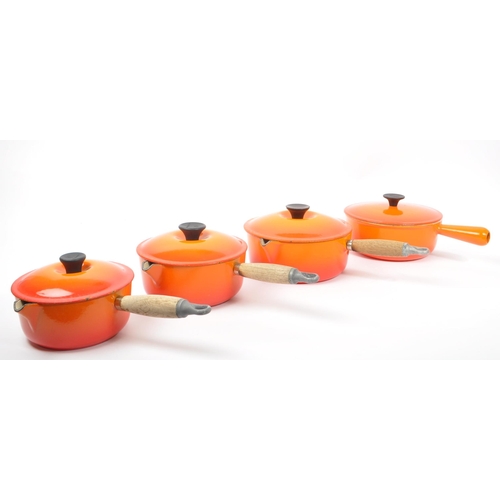 220 - Le Creuset - A collection of four varying sized cast iron Le Creuset saucepans with lids in volcanic... 