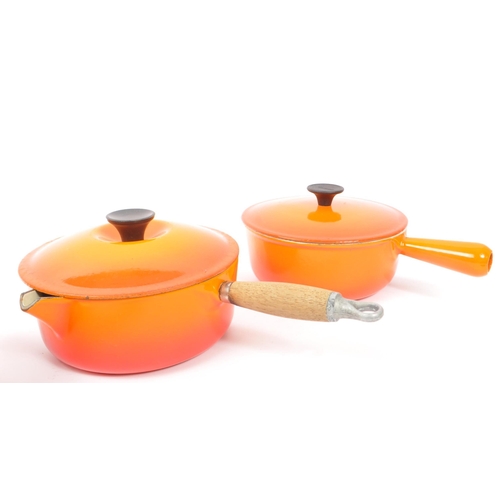 220 - Le Creuset - A collection of four varying sized cast iron Le Creuset saucepans with lids in volcanic... 