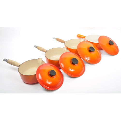 220 - Le Creuset - A collection of four varying sized cast iron Le Creuset saucepans with lids in volcanic... 