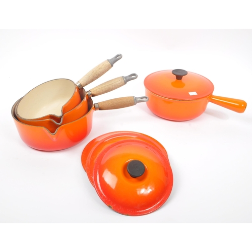 220 - Le Creuset - A collection of four varying sized cast iron Le Creuset saucepans with lids in volcanic... 