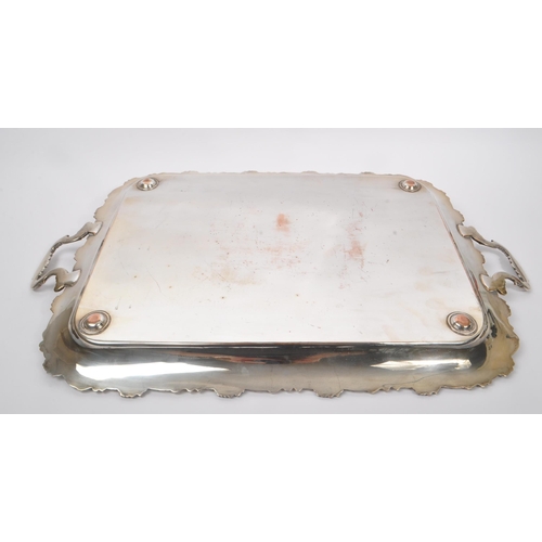 225 - An early 20th Century large silver plated ornate tray having relief foliate design to border and han... 