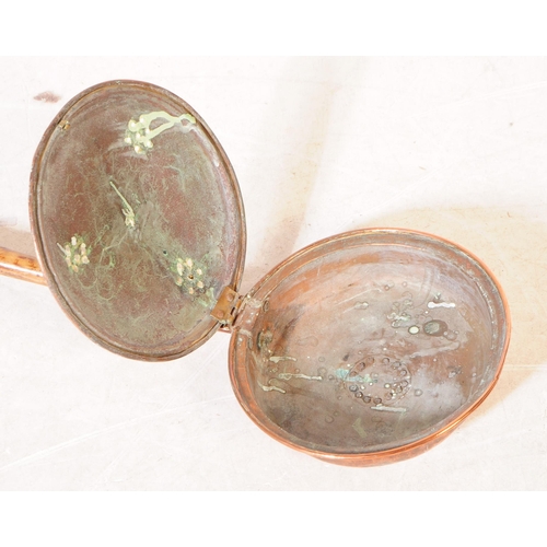 227 - A collection of 19th century and later copper and brass wares. To include flat irons and skillets, c... 