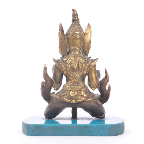 228 - A Burmese bronze Buddha figure on a blue rectangular resin base with hands in fists raised to front,... 