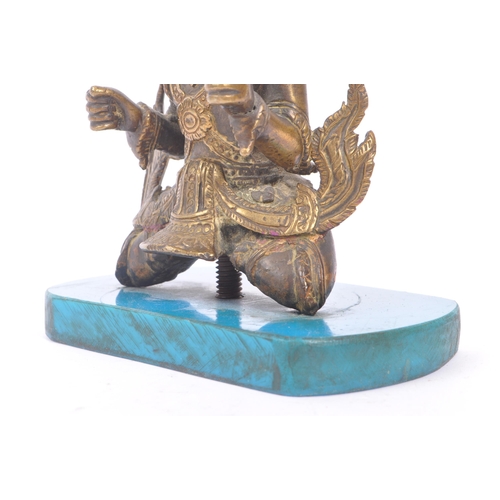 228 - A Burmese bronze Buddha figure on a blue rectangular resin base with hands in fists raised to front,... 