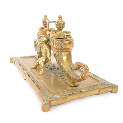 229 - A 19th Century large Chinese brass inkwell with liners, having rectangular base with two ink pots in... 