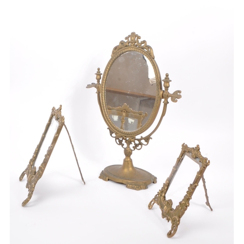 230 - Two early 20th Century rococo manner brass picture frames of varying size together with a brass oval... 