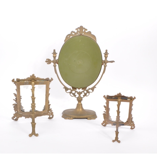 230 - Two early 20th Century rococo manner brass picture frames of varying size together with a brass oval... 