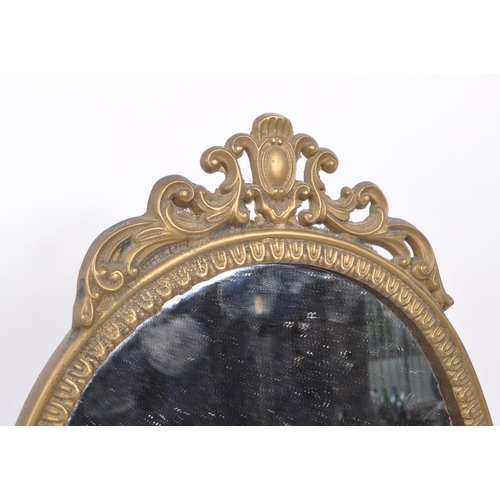 230 - Two early 20th Century rococo manner brass picture frames of varying size together with a brass oval... 