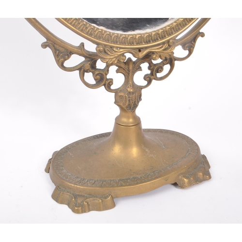 230 - Two early 20th Century rococo manner brass picture frames of varying size together with a brass oval... 