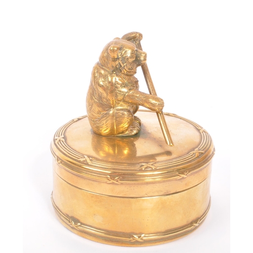 232 - An early 20th Century brass circular jewellery box / casket with lidded pot having figure of bear to... 