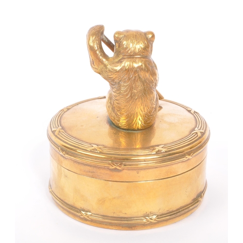 232 - An early 20th Century brass circular jewellery box / casket with lidded pot having figure of bear to... 