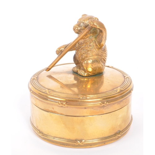 232 - An early 20th Century brass circular jewellery box / casket with lidded pot having figure of bear to... 