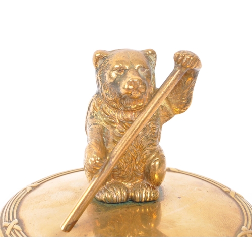 232 - An early 20th Century brass circular jewellery box / casket with lidded pot having figure of bear to... 