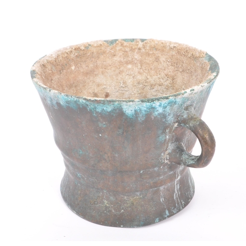 239 - A large late 17th Century bronze twin handled mortar bowl / pot having rounded handles to either sid... 
