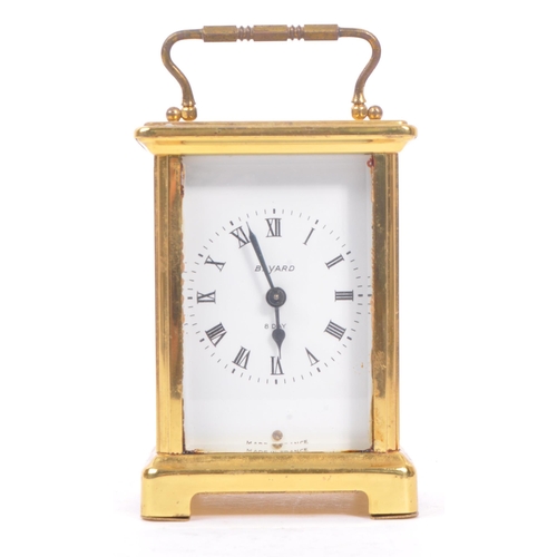 240 - Bayard, France - A 20th century brass eight day carriage clock. With carry handle to top, white face... 