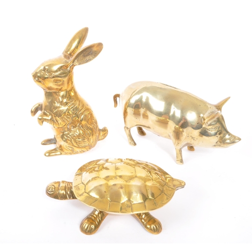 245 - A collection of 20th century brass animal figures. The collection to include a brass pig money box, ... 