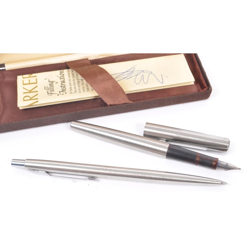 246 - Conway Stewart - A mid 20th century Conway Stewart 14ct nib fountain pen, alongside a Parker writing... 