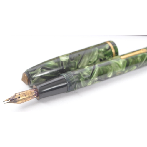 246 - Conway Stewart - A mid 20th century Conway Stewart 14ct nib fountain pen, alongside a Parker writing... 