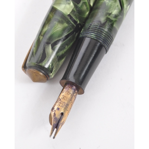 246 - Conway Stewart - A mid 20th century Conway Stewart 14ct nib fountain pen, alongside a Parker writing... 