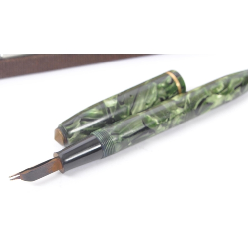 246 - Conway Stewart - A mid 20th century Conway Stewart 14ct nib fountain pen, alongside a Parker writing... 