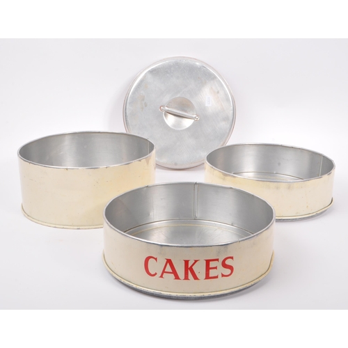 250 - A large mid Century three tiered cake tin of circular form having cream ground with silver lid and r... 